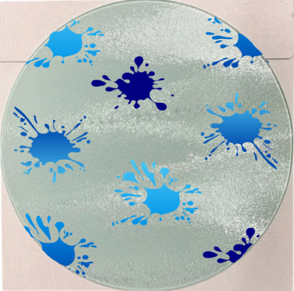 Round glass mat with blue handprint and splash designs on a beige floor.